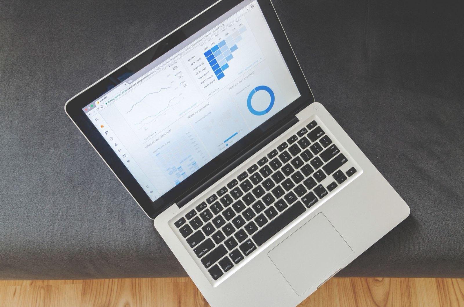 Overhead view of a laptop showing a web analytics dashboard