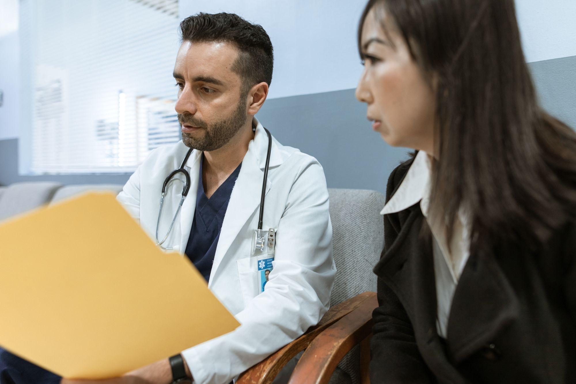 Clinician reviewing a chart with a patient during an in-office consult