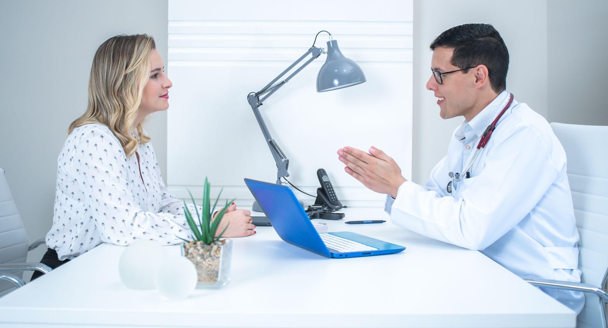 Woman talking through a plan with her clinician across a desk